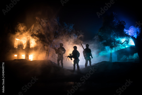 War Concept. Military silhouettes fighting scene on war fog sky background, World War Soldiers Silhouette Below Cloudy Skyline At night.