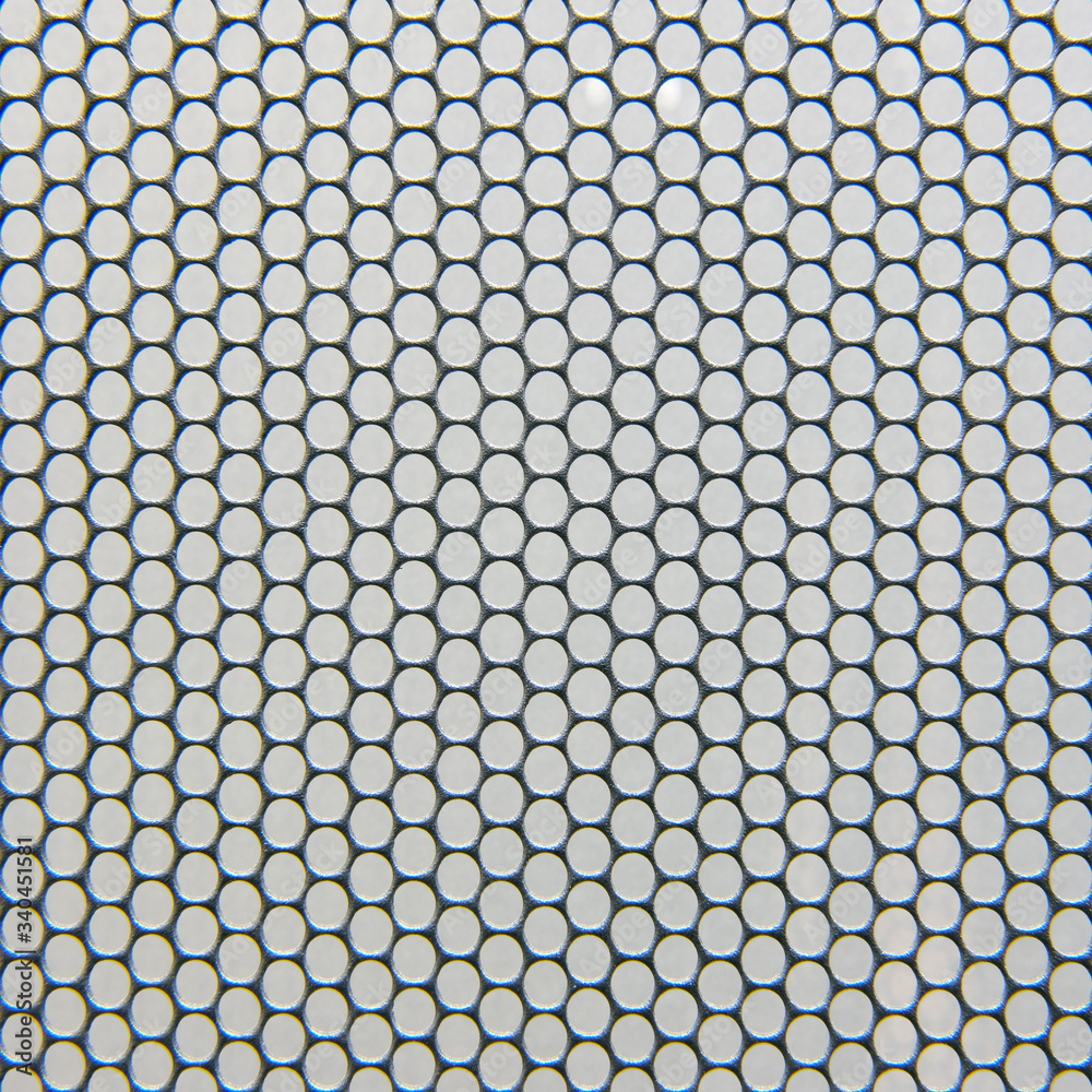 Metal grid background with round holes, gray texture of protective grill Metal grid background with round holes, gray texture of protective grill