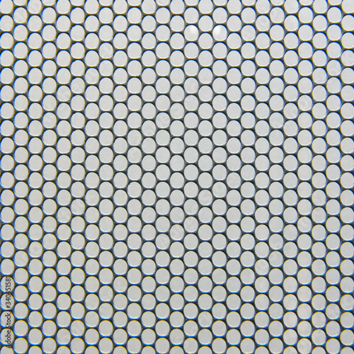 Metal grid background with round holes, gray texture of protective grill