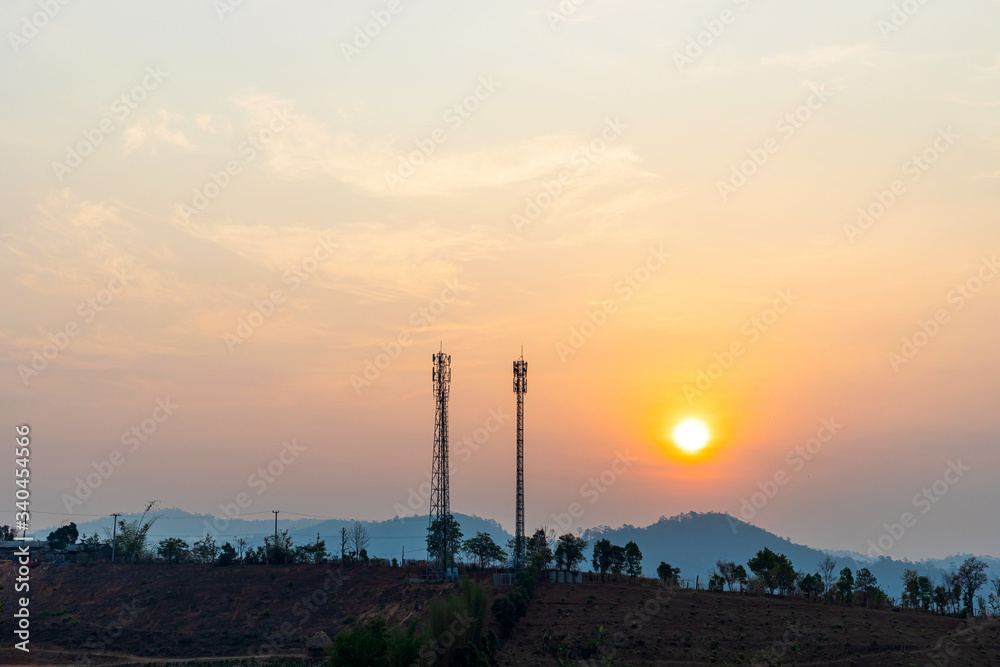 Telecommunication tower on top of the mountain  at sunrise or sunset time.
