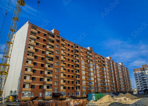 construction building process brick exterior facade common city architecture frame perspective landmark photography foreshortening from below vivid colors in bright summer day