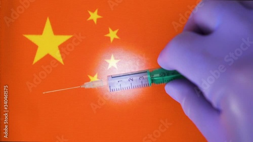 A small syringe with 3ml fluids on top of the China flag photo