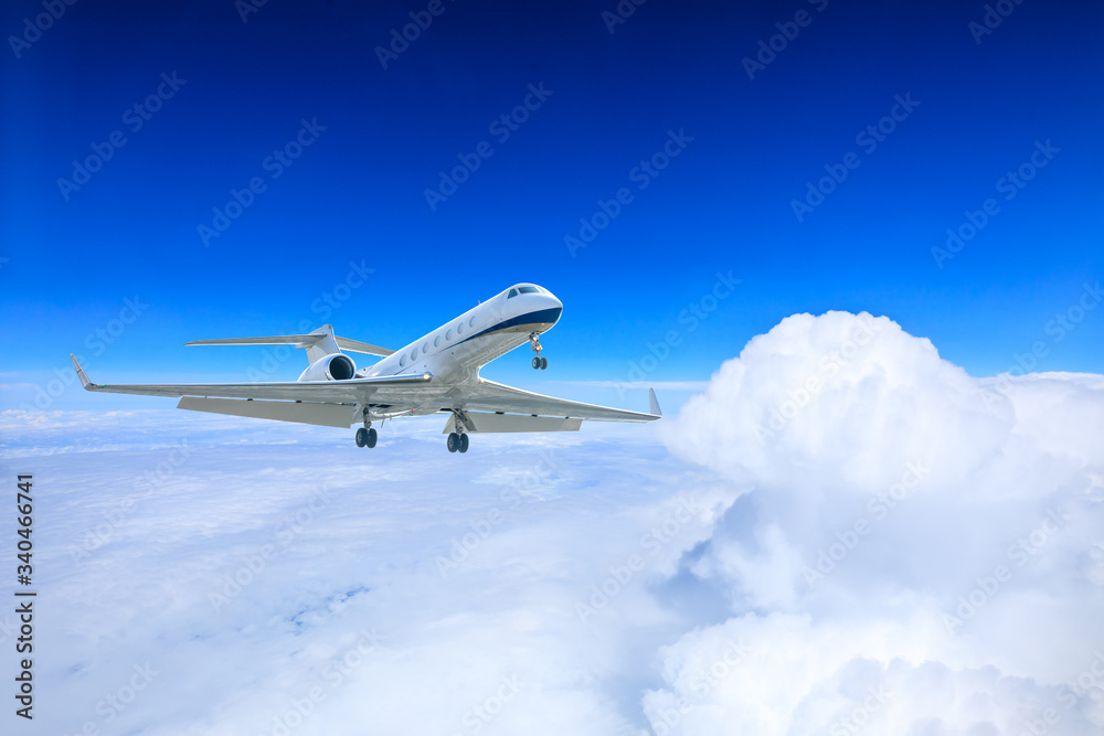 Obraz premium Commercial airplane flying above the clouds,travel concept.