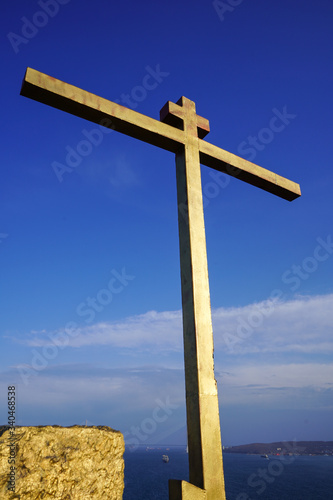 A Golden cross against a blue sky. Vladivostok, Russia