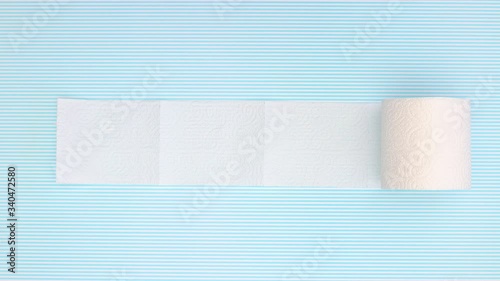 Toilet paper rolling on blue background - Stop motion 
