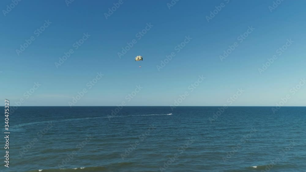 A Motor Boat Pulls A Parachute In The Open Sea A Motor Boat Pulls A Parachute In The Open Sea