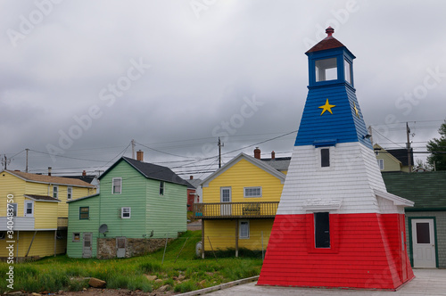 Print op canvas Cheticamp lighthouse and clapboard houses on Cape Breton Island Nova Scotia