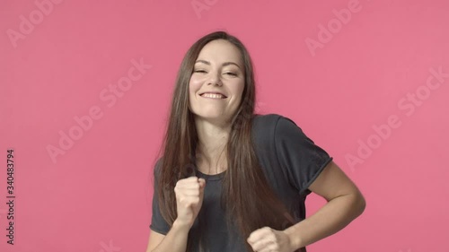 Lucky and carefree, happy caucasian woman dancing joyful, triumphing, feeling upbeat and cheerful, move rhythm music, smiling broadly satisfied of success, do champion dance, celebrate good news