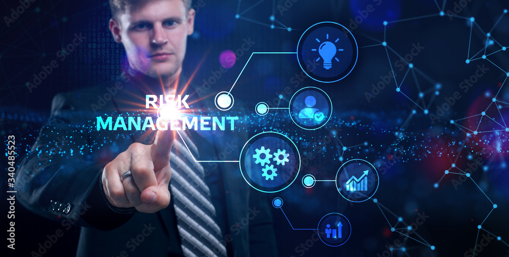 Business, Technology, Internet and network concept. Young businessman shows the word on the virtual display of the future: Risk management