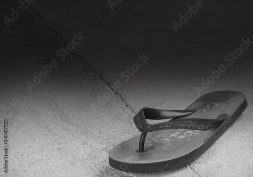 broken heart concept with black and white image of one pair of old shoes on Old plaster. black copy space. © wing-wing