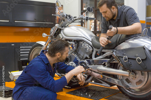 Two men in a motorcycle workshop. © Stavros