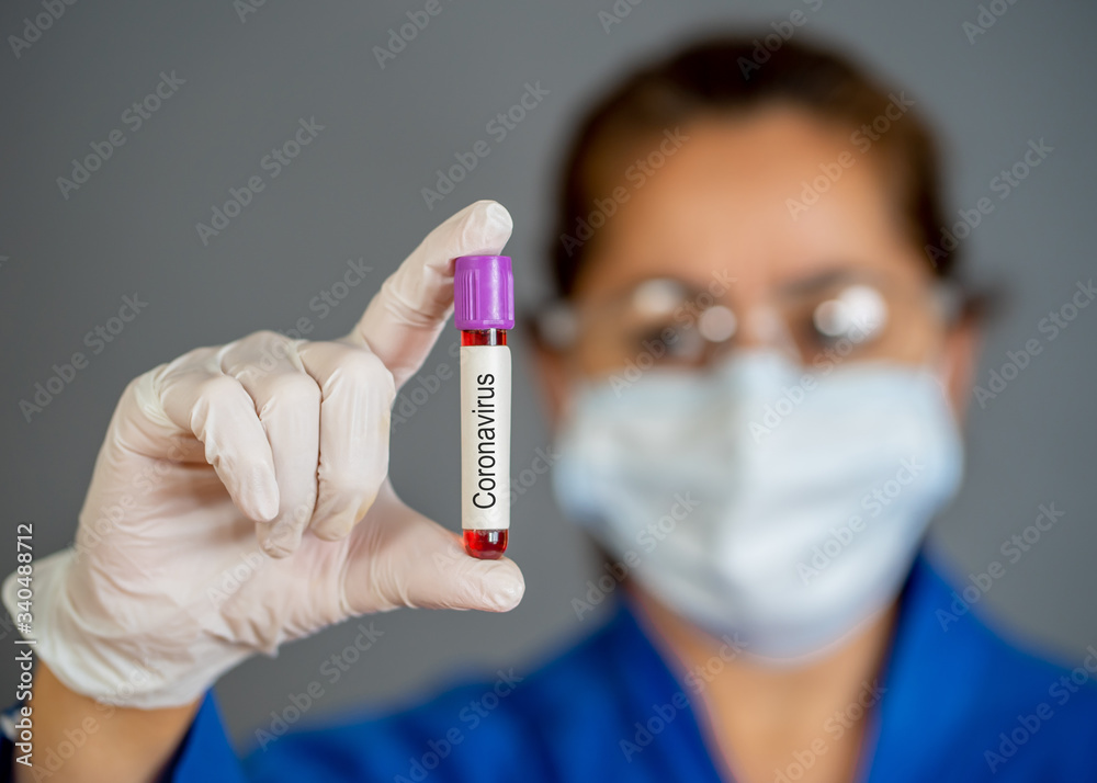 Scientist testing coronavirus positive blood sample researching for COVID-19 vaccine Scientist testing coronavirus positive blood sample researching for COVID-19 vaccine