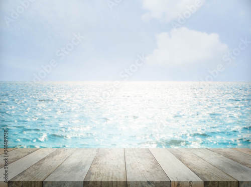 Wood perspective on sea blur image background. wood table top on blurred blue sea. thai sea concept.