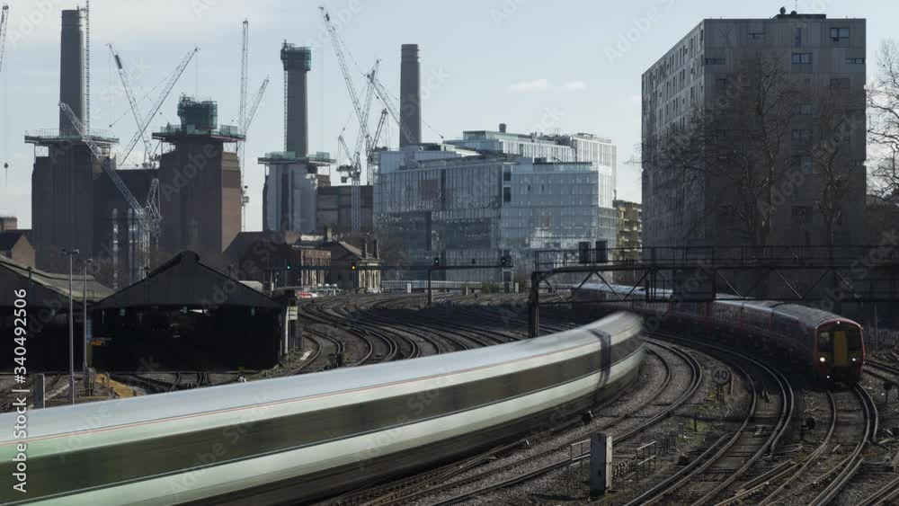 Timelapse shot of trains streaming in and out from Victoria station, Battersea Power Station in background, London, United Kingdom Timelapse shot of trains streaming in and out from Victoria station, Battersea Power Station in background, London, United Kingdom