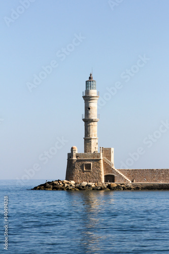 The old lighthouse guarding the entrance to the old Venetian harbour in Chania, Crete, Greece