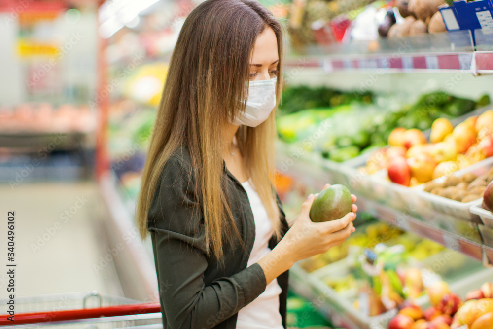Woman in medical mask shopping in supermarket.