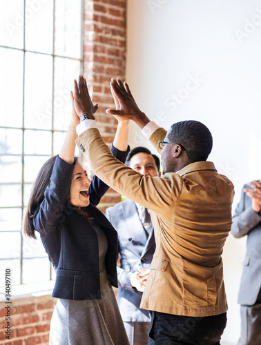 Successful business people doing a high five