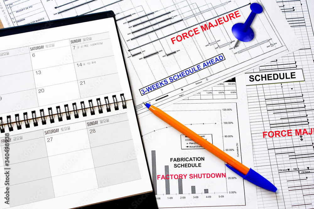 Force Majeure written overlay on a manufacturing schedule Force Majeure written overlay on a manufacturing schedule
