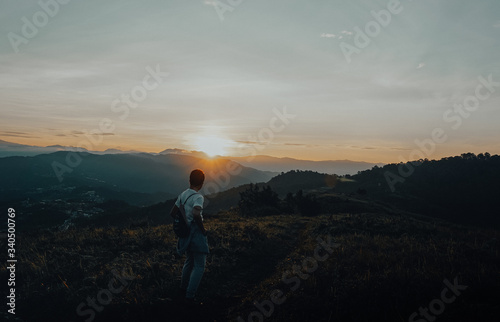 silhouette of a man walking in the mountains