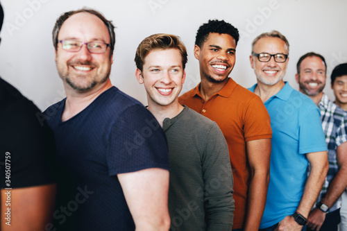 Happy men standing in a row photo