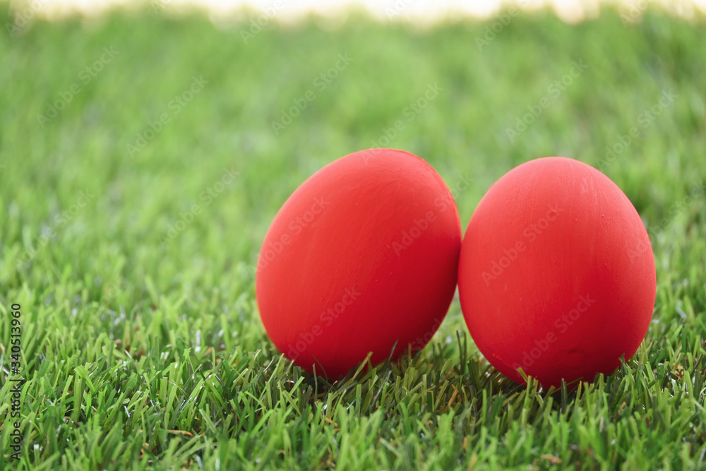 red easter egg on lawn green grass artificial, image of morning springtime concept