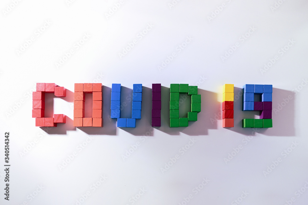 topic COVID-19 text message from wooden block toy of kid on white background topic COVID-19 text message from wooden block toy of kid on white background