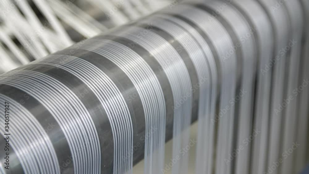 Stripes of plastic cords rolling around a spherical rod on an agricultural plant Stripes of plastic cords rolling around a spherical rod on an agricultural plant