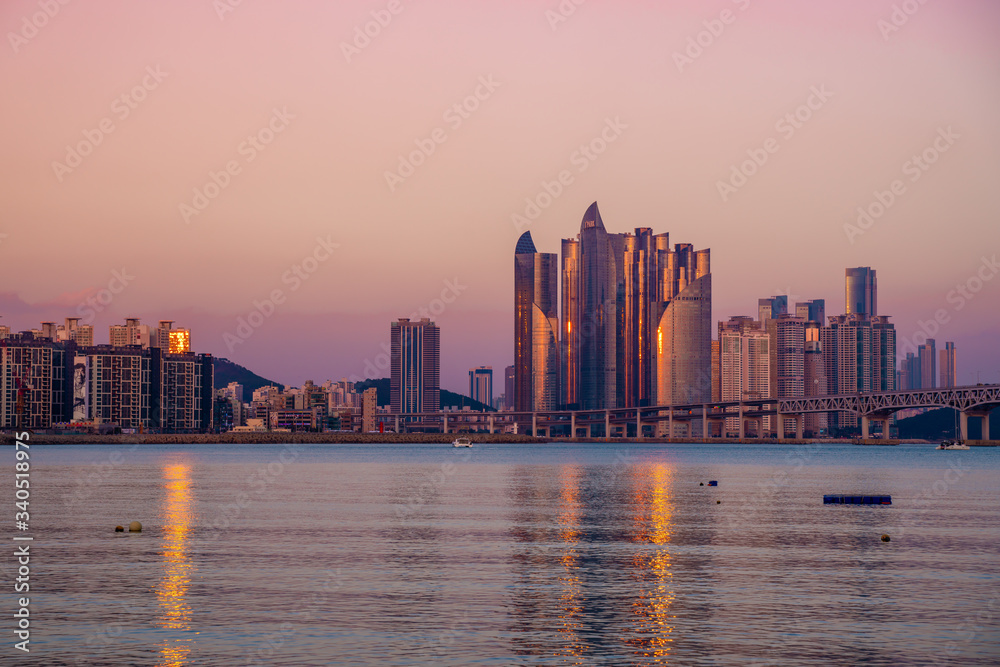Sunset in Busan, South Korean with pink sky on a sunny winter day with light reflecting of the buildings.