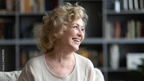 Head shot portrait pretty face of elderly woman sitting on couch looks aside, laughing feels happy and healthy, having wide charming toothy smile dental services ad, calm carefree retired life concept Free Download Head shot portrait pretty face of elderly woman sitting on couch looks aside, laughing feels happy and healthy, having wide charming toothy smile dental services ad, calm carefree retired life concept - GFXLoad