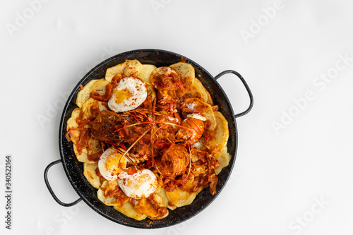 Formentera Lobster with fried potatoes, eggs and parsley in a traditional paella pan. Caldereta de bogavante de Formentera
