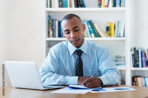 African american businessman stay at home and writing notes