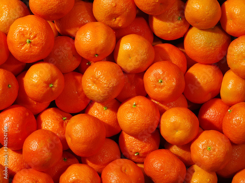 A lot of fresh orange tangerines