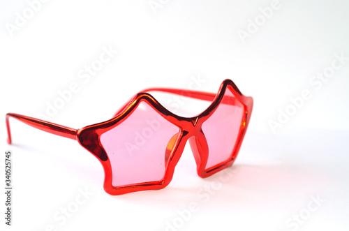 Red glasses in the form of stars on a white isolated background