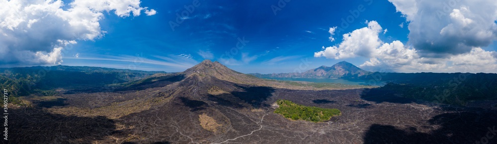 Aerial view of solidified black volcanic lava flows around the slopes of an active volcano.  (Mount Batur)