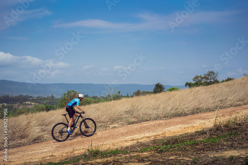 Mountain biker cycling, training and going up a steep climb.