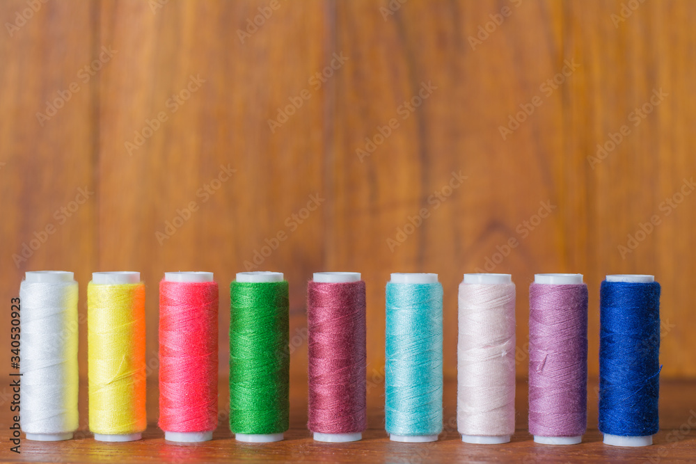 Colorful yarn on spool, yarn on tube, cotton, wool, linen thread,Color sewing threads on white background, top view Colorful yarn on spool, yarn on tube, cotton, wool, linen thread,Color sewing threads on white background, top view