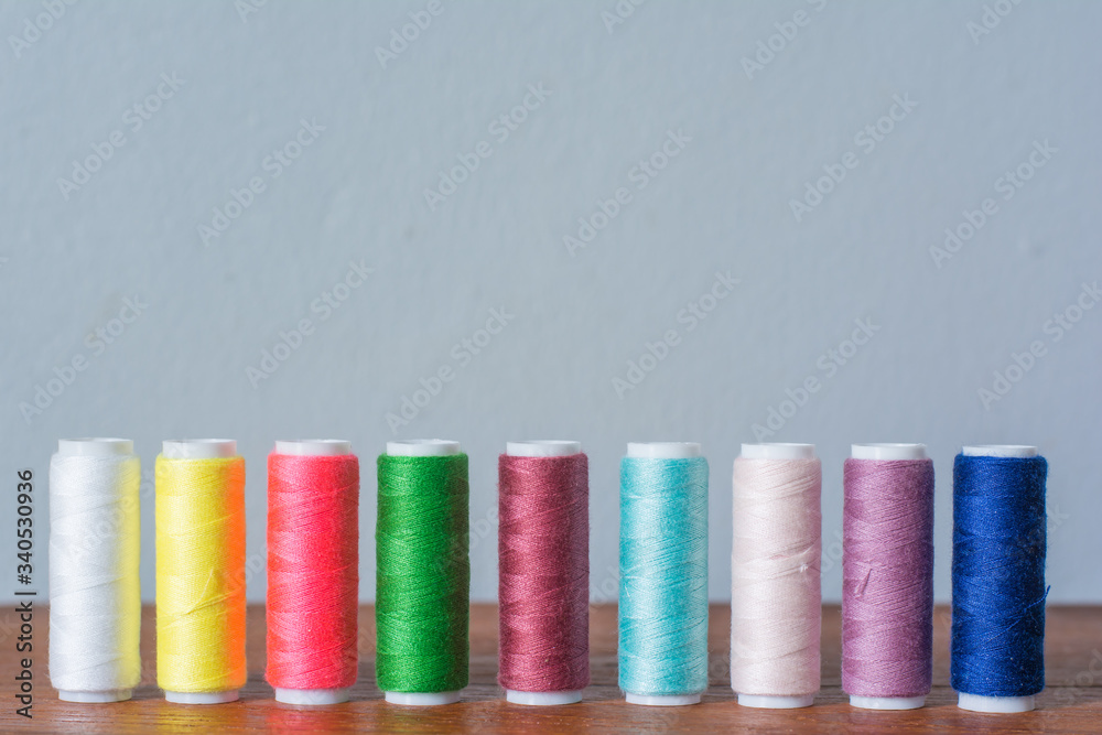 Colorful yarn on spool, yarn on tube, cotton, wool, linen thread,Color sewing threads on white background, top view Colorful yarn on spool, yarn on tube, cotton, wool, linen thread,Color sewing threads on white background, top view
