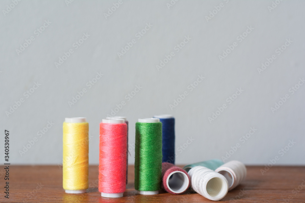 Colorful yarn on spool, yarn on tube, cotton, wool, linen thread,Color sewing threads on white background, top view Colorful yarn on spool, yarn on tube, cotton, wool, linen thread,Color sewing threads on white background, top view