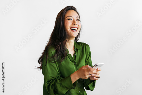 Happy woman texting on a phone