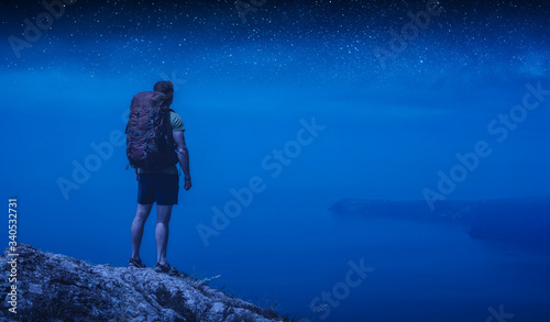 Man hiker under the starry sky