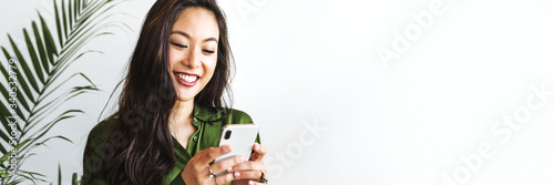 Happy woman texting on a smartphone
