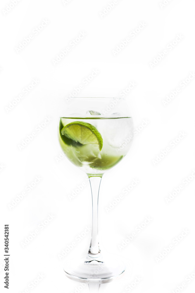 Rum based cocktail with lime in wine glass (variation of cuba libre) on the white background. Selective focus. Shallow depth of field.
Rum based cocktail with lime in wine glass (variation of cuba libre) on the white background. Selective focus. Shallow depth of field.