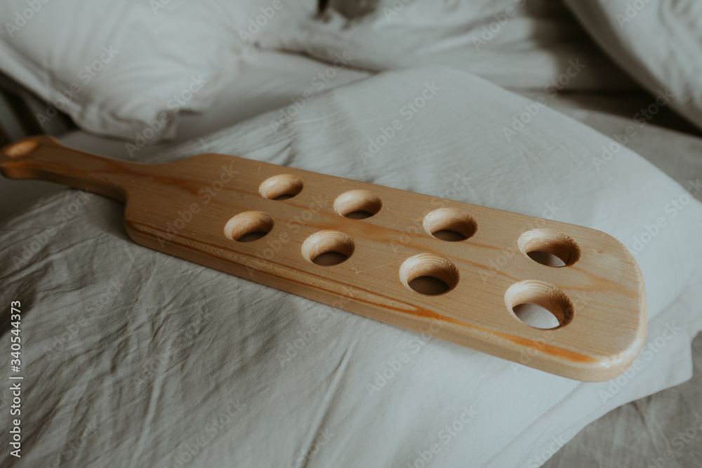 Wooden paddle with holes for corporal punishment. Child abuse, domestic
