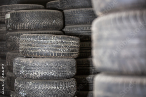 Worn out or used car tires in warehouse, service center, transportation concept
