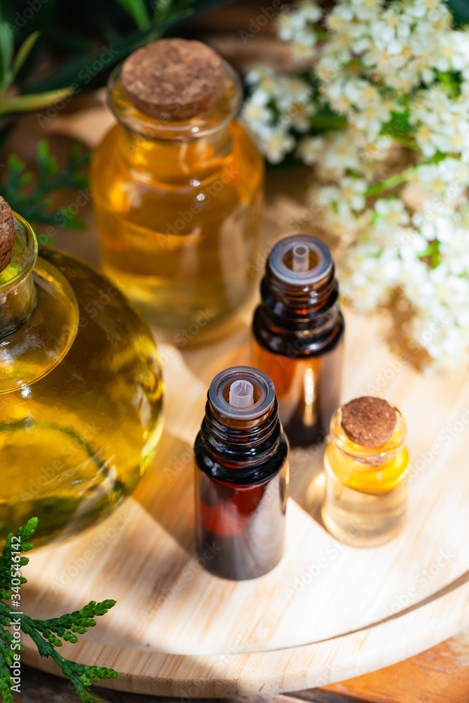 Assortment of natural oils in glass bottles on wooden background. Concept of pure organic ingredients in cosmetology. Atmosphere of harmony, relax, spa. Close up macro. Healthy lifestyle. Assortment of natural oils in glass bottles on wooden background. Concept of pure organic ingredients in cosmetology. Atmosphere of harmony, relax, spa. Close up macro. Healthy lifestyle.
