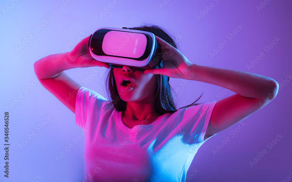 Surprised millennial girl in virtual reality glasses