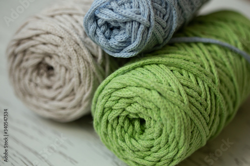 Skeins of natural cotton threads in green, blue and gray colors