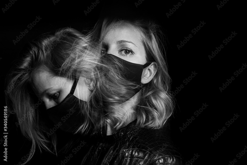 attractive blonde woman face black mask. Dark mood background. environmental disaster polluted air. Virus protection covid corona Long exposure creative artisic black and white double portrait. Badass