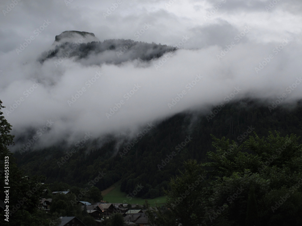 Clouds descend on evening mountains