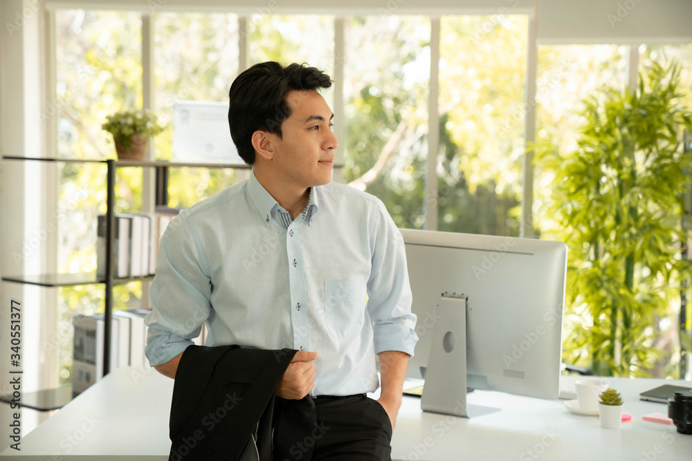 Portrait of young asian businessman with his working table. Portrait of young asian businessman with his working table.